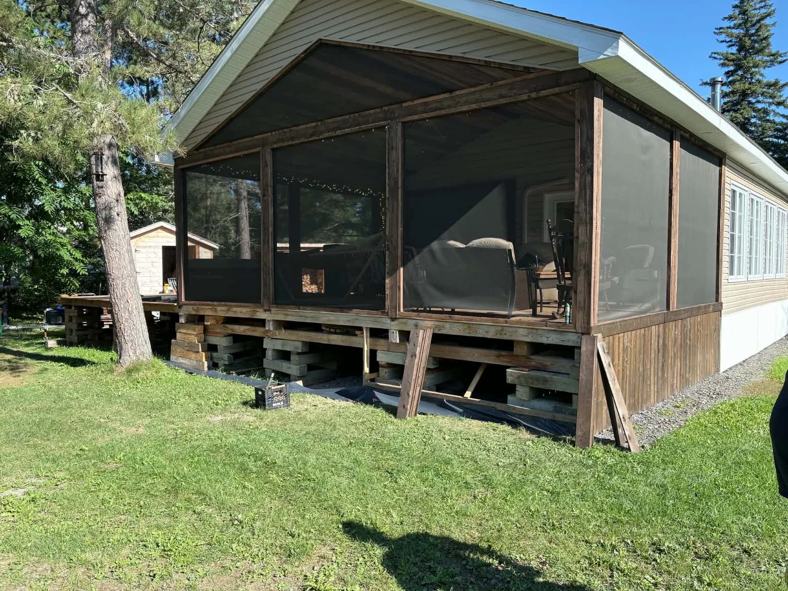 Cottage porch with exposed framing before skirting